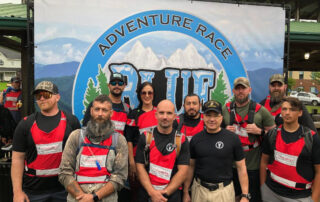 Group photo of members from the Appalachian Circuit Veterans Treatment Court standing in front of the Blue Ridge Adventure Race sign